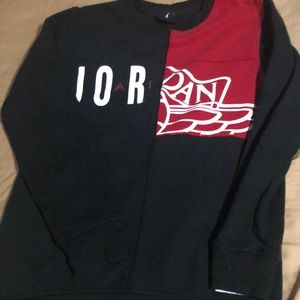 Jordan black round neck with red on the front of it.